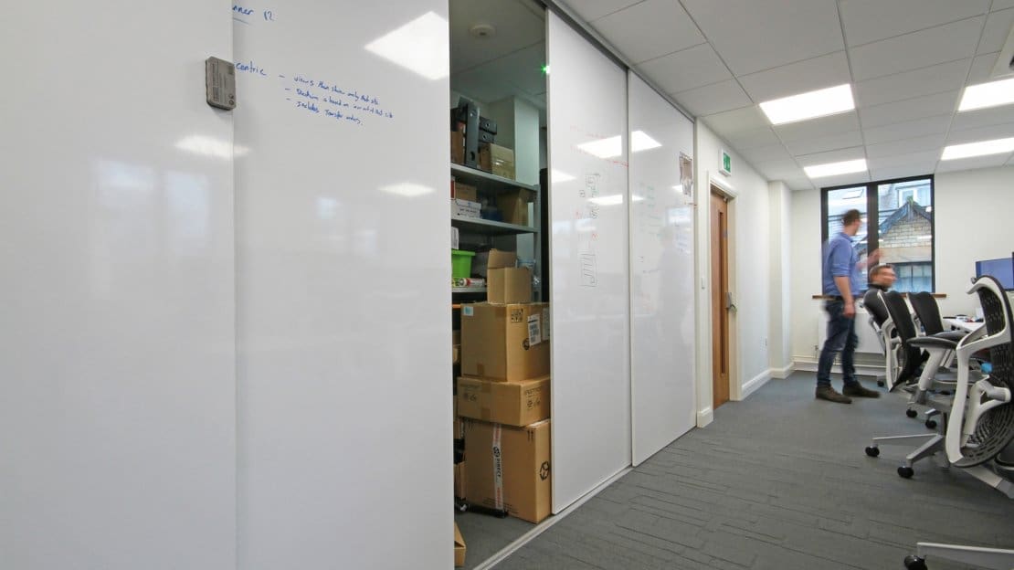 Whiteboard walls with storage area behind